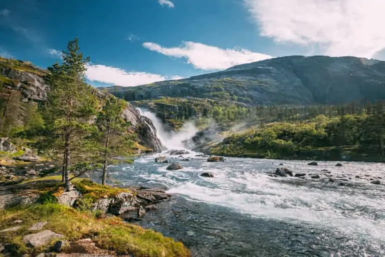 Kinsarvik, Hordaland, Norway. Waterfall Nykkjesoyfossen In Hardangervidda Mountain Plateau. Summer Sunny Day. Height Of 49 m. Famous Norwegian Landmark And Popular Destination.